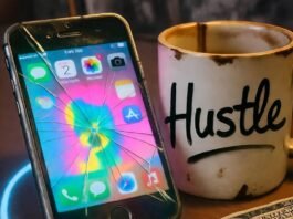 Top Tips for Running Paid Ads with Influencers That Convert Cracked phone with vibrant ad, chipped "Hustle" mug, crumpled $100 bill on messy desk.