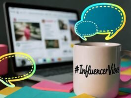 How to Plan a Winning Influencer Marketing Campaign? Cluttered desk with laptop, "#InfluencerVibes" mug, neon sticky notes, and speech bubbles.